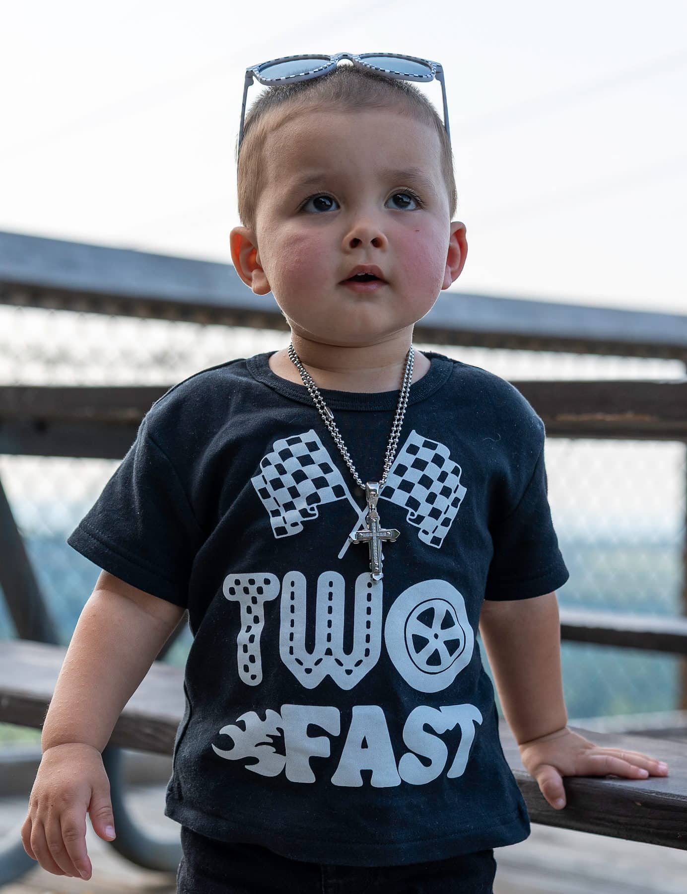 A two year old in a race day shirt at his second birthday session