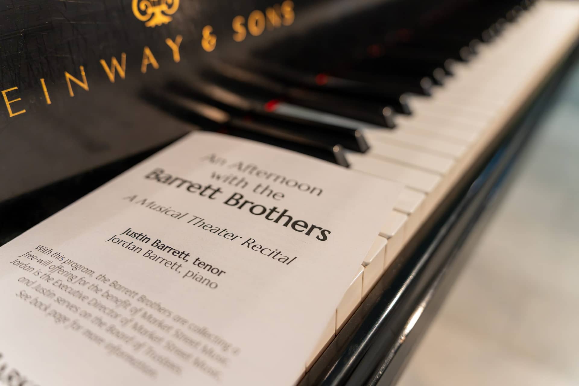 Recital programme resting on the keys of a Steinway grand piano