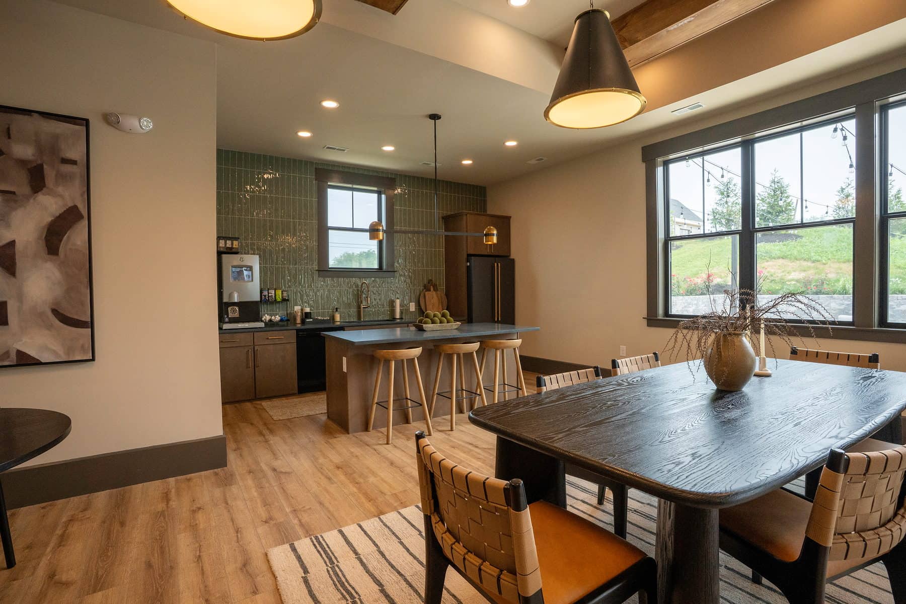 A long communal table in front of the clubhouse bar and kitchen