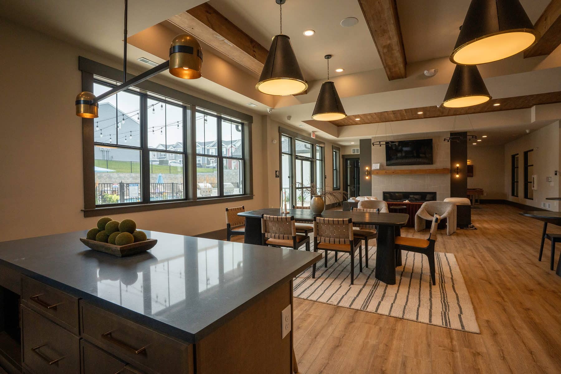 A clubhouse island in the foreground opening to lounge and dining beyond