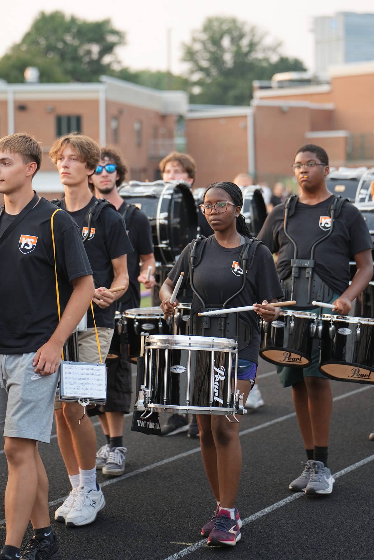 A high school drumline marching in step during band camp