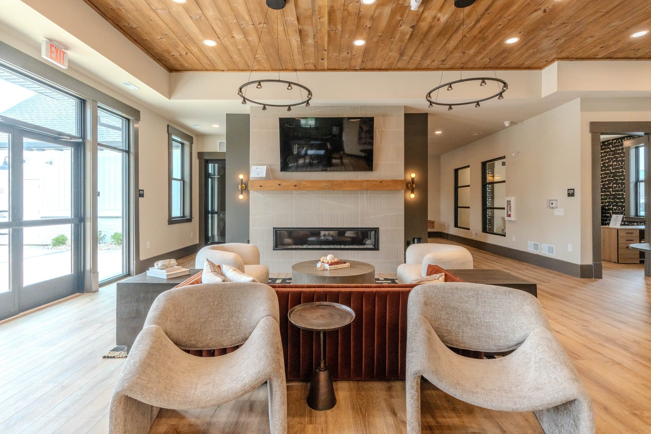 Modern clubhouse lounge with fireplace and wood ceiling