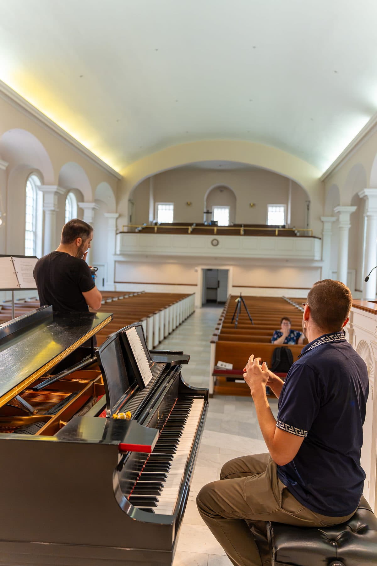 Two musicians running the programme in an empty barrel-vaulted sanctuary before the audience arrives